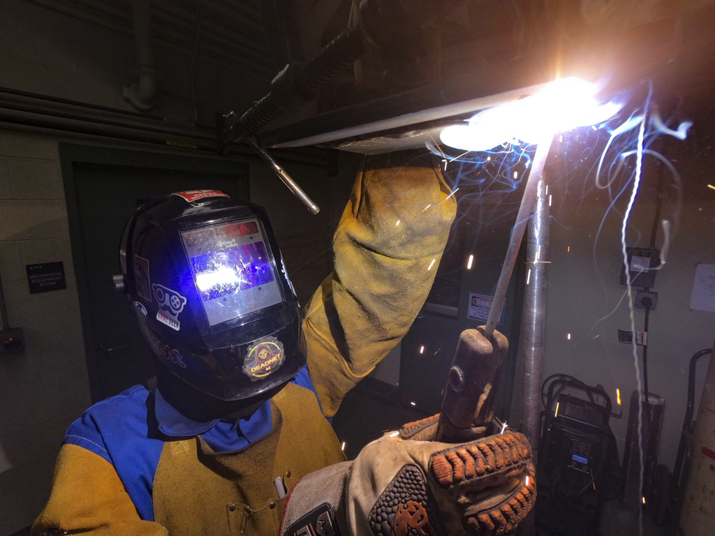 Industrial arc welding of steel components in a fabrication workshop