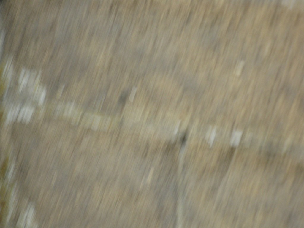 Abrasive sandblasting preparing a metal surface for coating